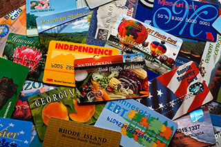 A pile of brightly colored cards from different states, similar to credit cards.